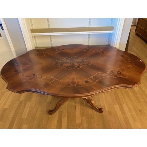 7 - An Italian Sorrento dining table, the top having inlaid walnut and marquetry floral effect pattern, ... 