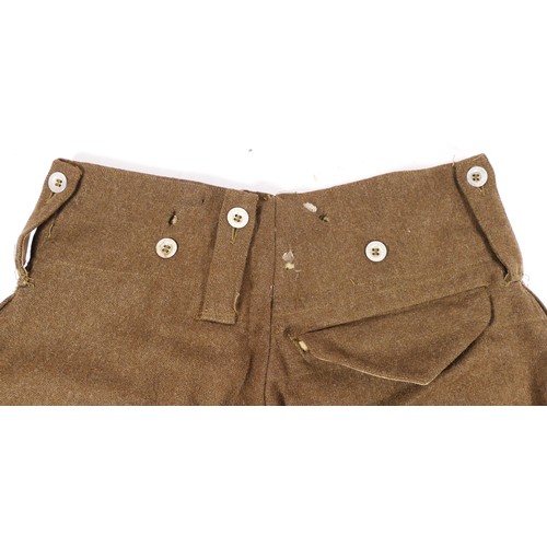 9 - A pair of Second World War Australian Battle dress trousers, signed 452 on internal waistband, toget... 
