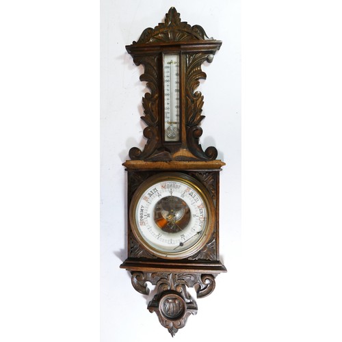 18 - An Edwardian carved oak wall barometer