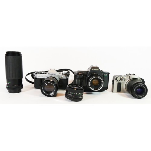 47 - Three Canon cameras to include an AE-1, a EOS600 and an EOs IX, with lens, together with two lenses,... 