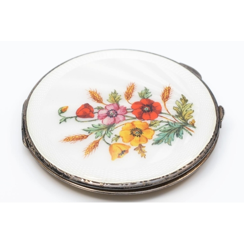 19 - A silver and enamel powder compact, Birmingham 1940,  floral decoration with white guilloche enamel ... 