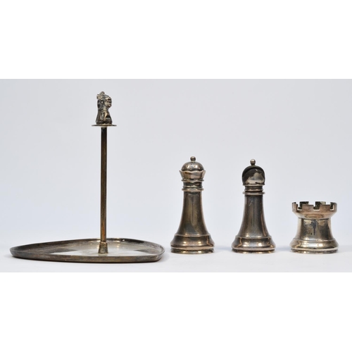 29 - Asprey & Co. Ltd, a silver chess related three piece cruet set, London 1961/65/67, the triangular bo... 