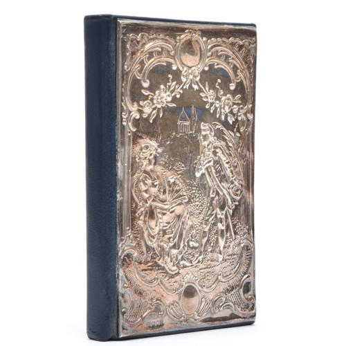 34 - A silver covered address book, London 1991, with embossed courting couple scene, unused, 12 x 8cm