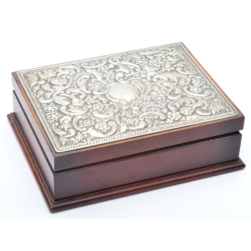 30 - A silver mounted jewellery box, Sheffield 1992, with embossed floral and scroll decoration, opening ... 