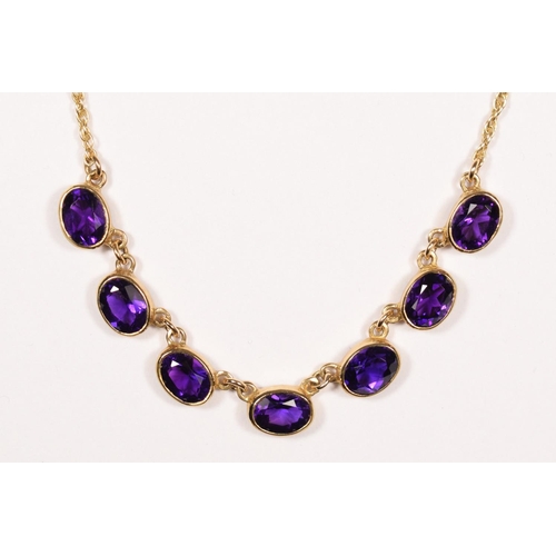 50 - A Victorian style 9ct gold and amethyst necklace, Birmingham 1967, collet set with seven mixed cut s... 