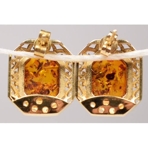 51 - A continental 14k gold and amber pair of ear studs, bearing control marks, 18 x 15cm overall, 5.8gm.