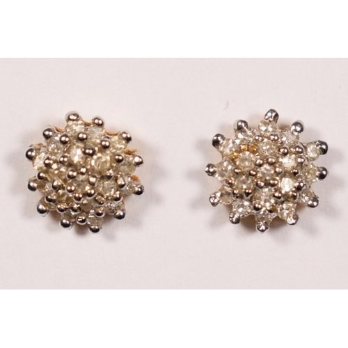 56 - A pair of 18ct gold and diamond cluster ear studs, stated weight 0.28cts, diameter 8mm, 2gm.