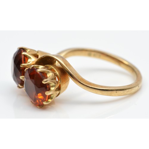 67 - A vintage 9ct gold and two stone citrine crossover ring, diameter 9mm each, R 1/2, 6.7gm