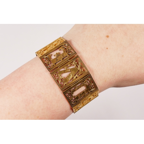 73 - A Victorian gold turquoise book bracelet, retailed by John Brogden, composed of pierced and engraved... 