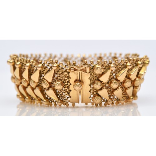 75 - An Italian 18ct gold woven bracelet, stamped 750, with applied decoration, 17.5cm, 33.1gm