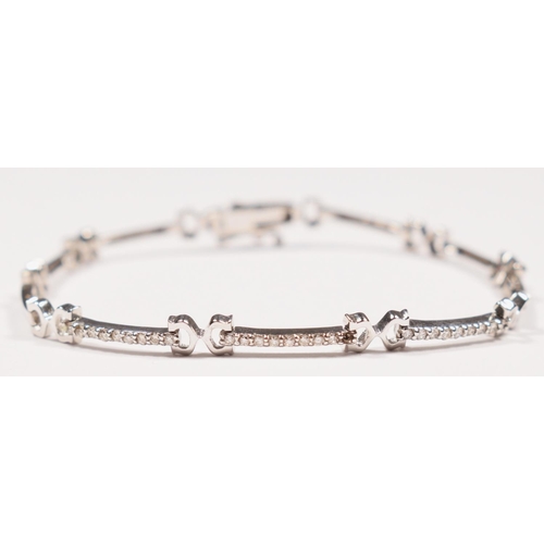 80 - An 18K white gold and diamond set bracelet, three links set with nine brilliant cut stones each, sti... 