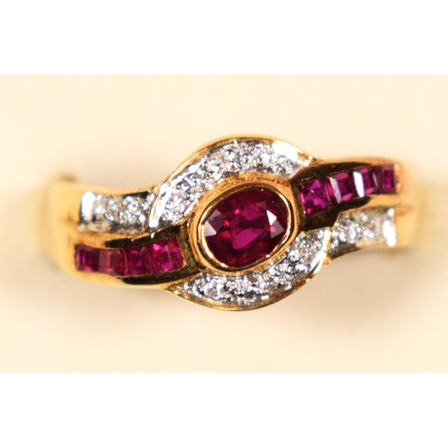 81 - An 18ct gold (750) ruby and diamond ring, collet set with an oval mixed cut stone , flanked by bague... 