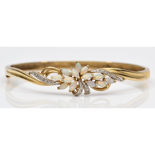 86 - A 9K gold opal and diamond floral spray fronted bracelet, 59 x 50mm internal, 10.8gm