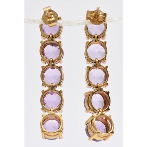 94 - A 9ct gold pair of amethyst drop earrings, articulated claw set with facetted stones, length 33mm, 6... 