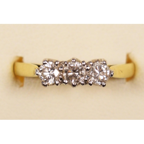 95 - An 18ct gold three stone diamond ring, claw set with brilliant cut stones, London 1986, stated weigh... 