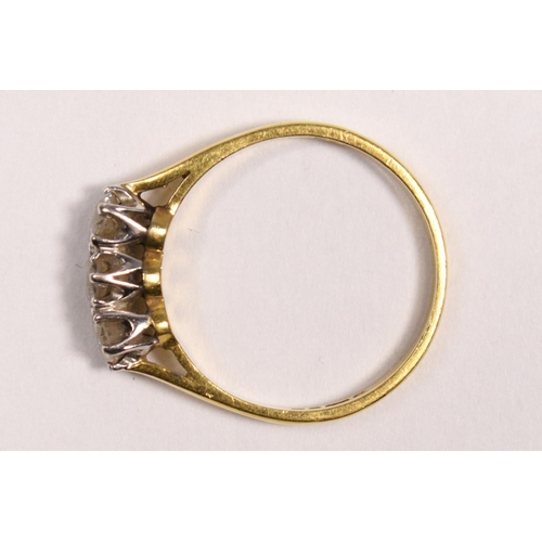 95 - An 18ct gold three stone diamond ring, claw set with brilliant cut stones, London 1986, stated weigh... 