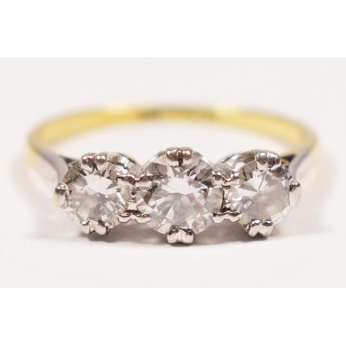 96 - An 18ct gold three stone diamond ring, claw set with graduated brilliant cut stones, approximately 0... 