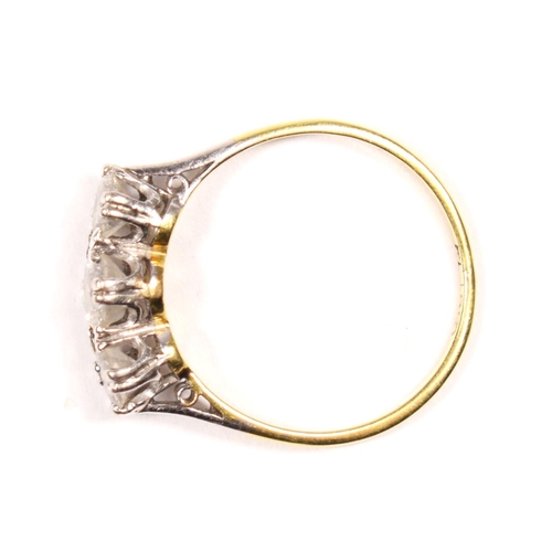 96 - An 18ct gold three stone diamond ring, claw set with graduated brilliant cut stones, approximately 0... 