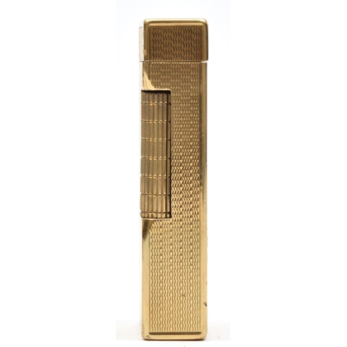 127 - Dunhill, a 9ct gold rollagas cigarette lighter, London 1967, with engine turned decoration, 105gm, o... 