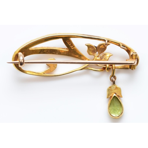 123 - A Victorian 15ct gold peridot and half pearl scroll brooch, stamped 15ct, 35mm, 3.6gm