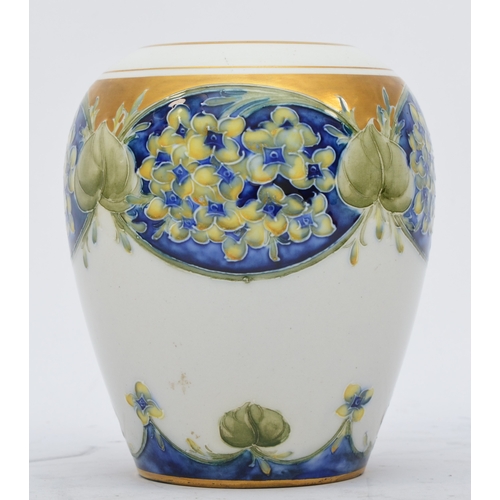 172 - A Moorcroft Macintyre baluster vase, Lilac pattern, hand painted with gilt decoration and rim, signe... 