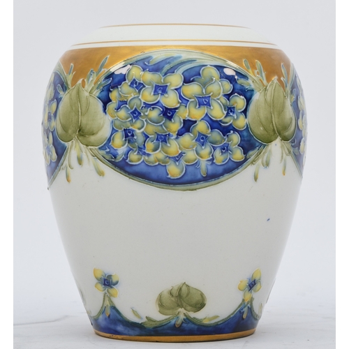 172 - A Moorcroft Macintyre baluster vase, Lilac pattern, hand painted with gilt decoration and rim, signe... 