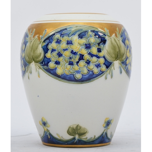 172 - A Moorcroft Macintyre baluster vase, Lilac pattern, hand painted with gilt decoration and rim, signe... 