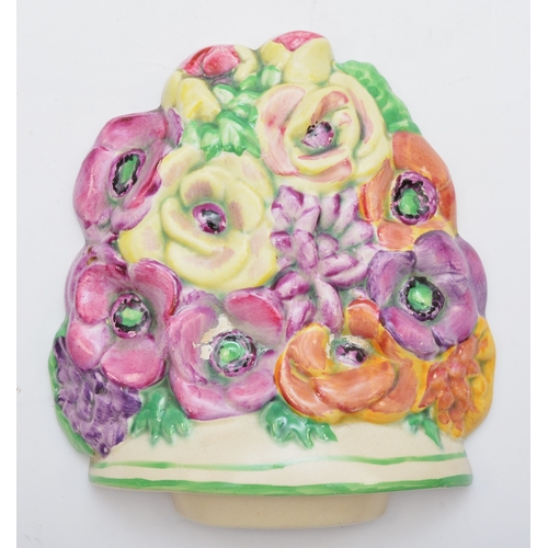 174 - A Beswick wall plaque, c.1930s, depicting flowers, hand painted, stamped on verso 565, 14.5cm.