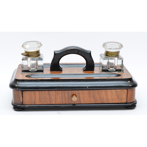 223 - A late Victorian ebonised and walnut double inkstand, with two glass ink bottles, two pen trays and ... 