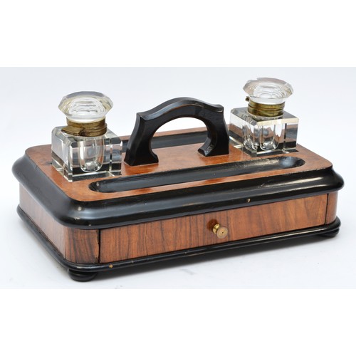 223 - A late Victorian ebonised and walnut double inkstand, with two glass ink bottles, two pen trays and ... 