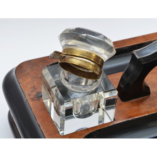 223 - A late Victorian ebonised and walnut double inkstand, with two glass ink bottles, two pen trays and ... 