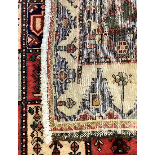 228 - A Persian Bakhtiari woven wool rug, having burgundy and ivory ground with square floral motifs and r... 