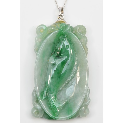 241 - An 18k white gold mounted carved jadeite pendant, single koi carp to one side, two to the other, 45 ... 