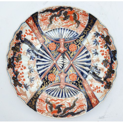 244 - A Japanese Imari dish, of four fan design, one fan with birds, the other a lobed forest, diameter 32... 