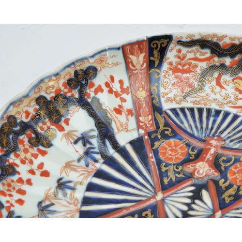 244 - A Japanese Imari dish, of four fan design, one fan with birds, the other a lobed forest, diameter 32... 