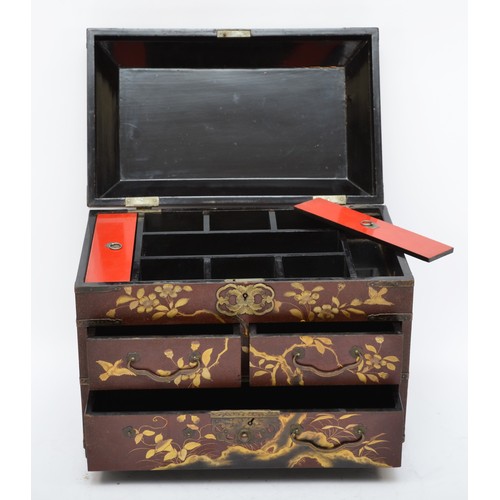 245 - A Japanese lacquer jewellery box, with red and gold floral decoration, hinged lid revealing a fitted... 