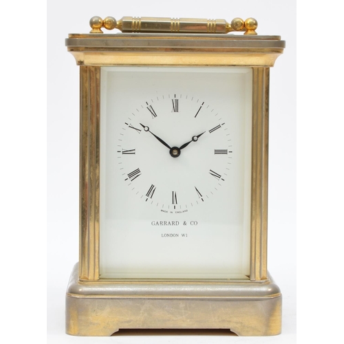 264 - Garrard & Co. London, a large brass striking carriage clock, the white enamel dial with Roman numera... 