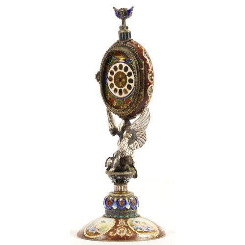 267 - A 19th century Viennese enamel table clock, the oval case containing a pocket watch movement, the ca... 