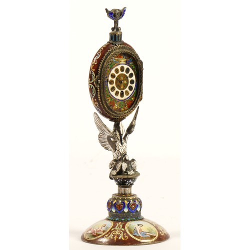 267 - A 19th century Viennese enamel table clock, the oval case containing a pocket watch movement, the ca... 