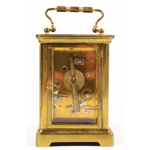 248 - A brass carriage alarm time piece, white enamel dial with Roman numerals and subsidiary alarm dial, ... 