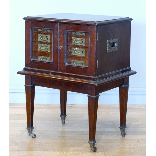 337 - A 19th century oak campaign canteen of cutlery cabinet on stand, the glazed doors enclosing a bank o... 