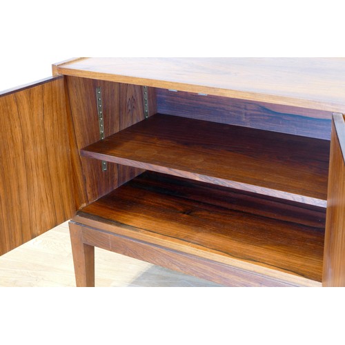 354 - A Danish rosewood sideboard, c.1960s, of long low form with plain top over two banks of three gradua... 