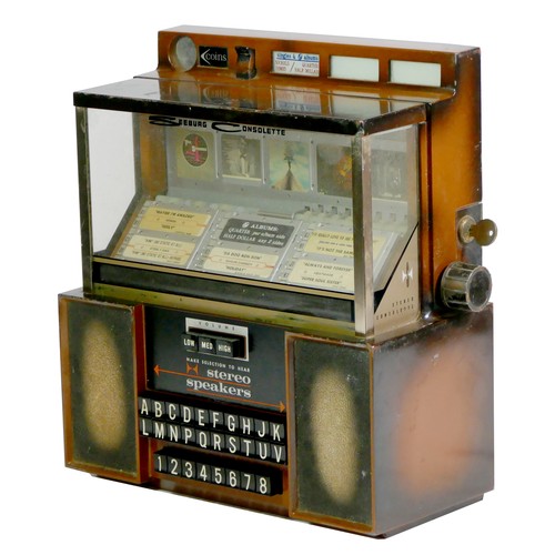 413 - A Seeburg Consolette wall mounted jukebox, model SCH 3-4, with stereo speakers, three volume keys an... 