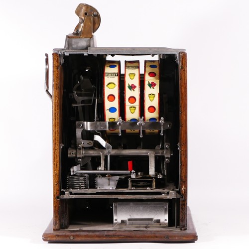 425 - A Mills Poinsettia slot machine, one arm bandit, c.1929, restored and working on a 1D coin, wooden c... 