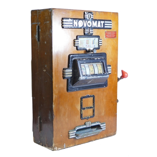 453 - A Novomat slot machine, one arm bandit, c.1950's, works on a old 2p coin, wooden case with cast plas... 