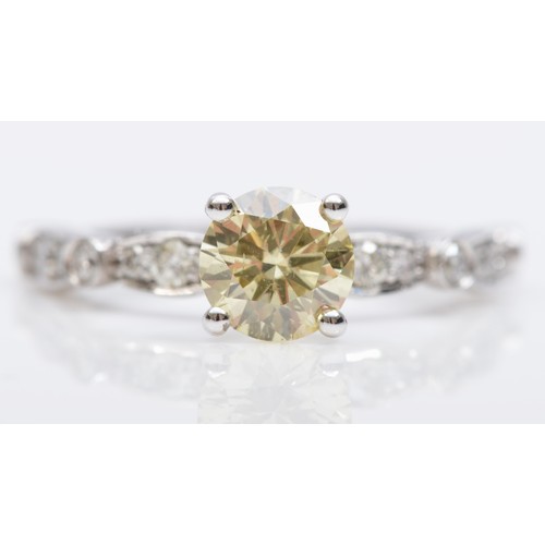 68 - A 14K white gold single stone with natural fancy yellow brilliant cut diamond ring, AIG certificate ... 