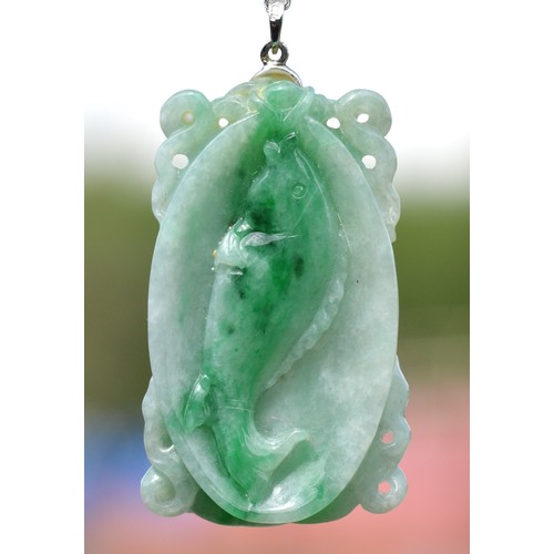 241 - An 18k white gold mounted carved jadeite pendant, single koi carp to one side, two to the other, 45 ... 