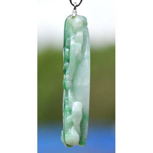 241 - An 18k white gold mounted carved jadeite pendant, single koi carp to one side, two to the other, 45 ... 