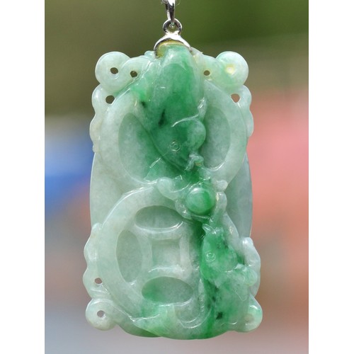 241 - An 18k white gold mounted carved jadeite pendant, single koi carp to one side, two to the other, 45 ... 