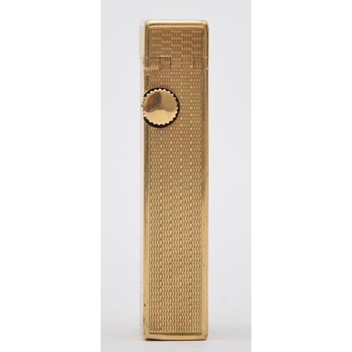 127 - Dunhill, a 9ct gold rollagas cigarette lighter, London 1967, with engine turned decoration, 105gm, o... 